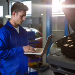 mechanic-working-on-laptop-in garage